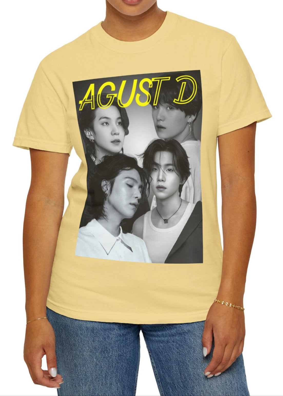 Agust D | SUGA BTS Unisex T-Shirt in butter – Monochrome Collage. A bold black-and-white collage featuring multiple portraits of Agust D and SUGA, with a transparent-outlined text effect for a modern, artistic touch. ModeK Vetements.