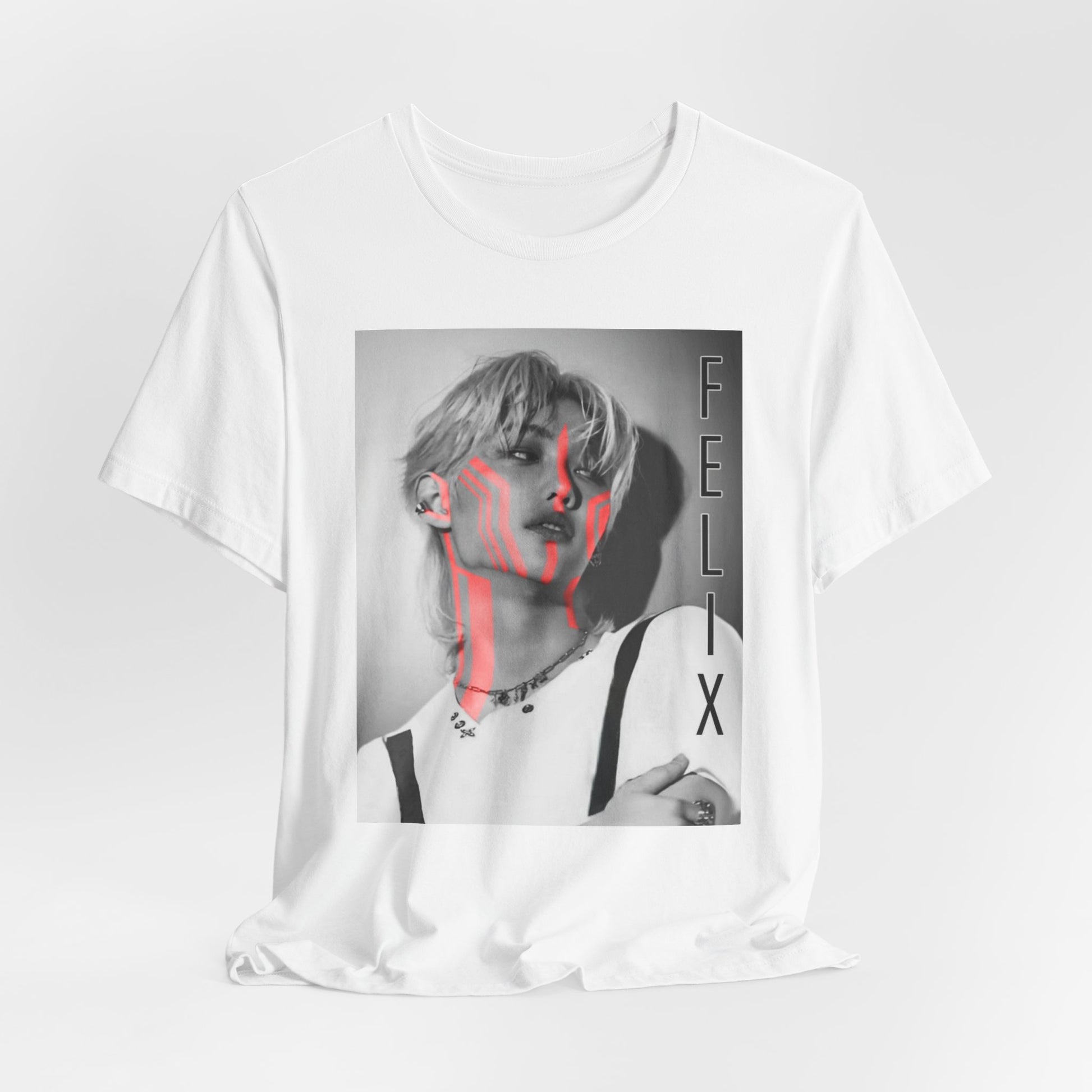 Flat-lay of the Felix Lee Stray Kids unisex T-shirt in white, featuring a monochrome portrait with bold neon pink accents. The design contrasts soft grayscale tones with futuristic neon highlights, creating a modern and artistic aesthetic. Made from 100% Airlume cotton for lightweight comfort. From ModeKVetements.