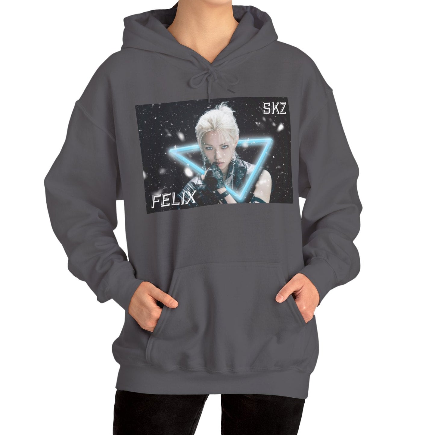 Unisex cotton-poly blend hoodie in charcoal, featuring a visual print of Felix from Stray Kids, framed by a glowing blue neon triangle amid falling snow on a dark background. From ModeK Vetements.