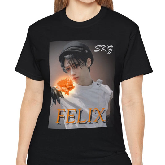 Felix Stray Kids unisex T-shirt in black, inspired by the 143 MV. Features Felix in white costume with glowing orange flower, contrasted against a dark, cinematic background. ModeK Vetements.