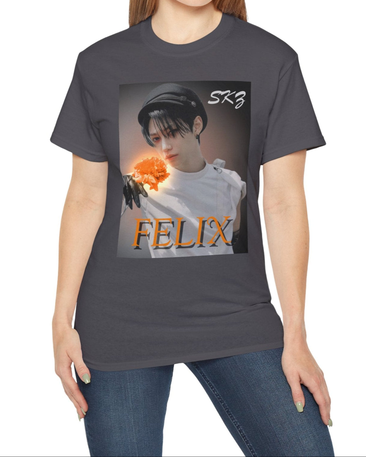 Felix Stray Kids unisex T-shirt in charcoal, inspired by the 143 MV. Features Felix in white costume with glowing orange flower, contrasted against a dark, cinematic background. ModeK Vetements.