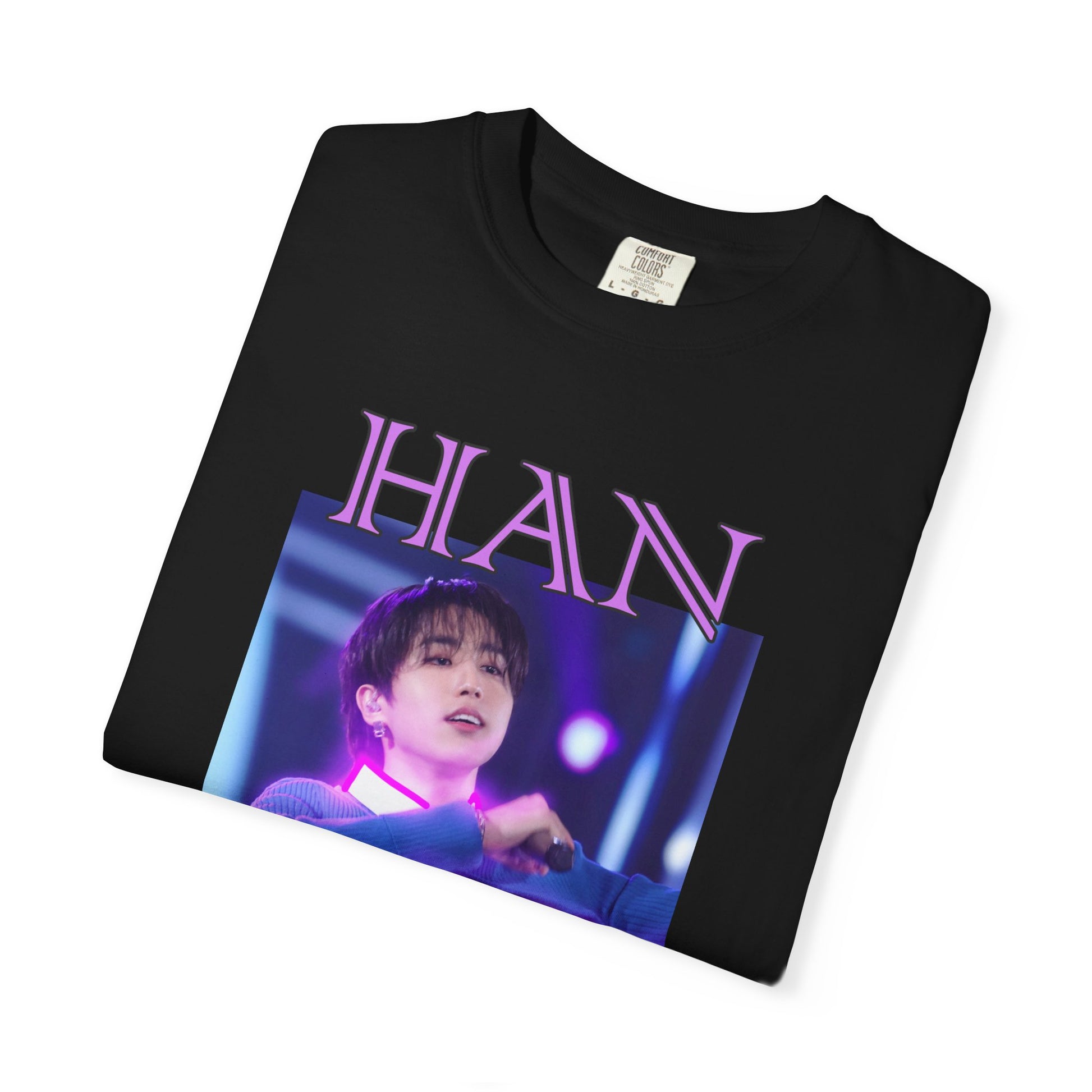 Folded Han Stray Kids Unisex T-Shirt in black – Neon Energy. A striking design featuring Han performing on stage, outlined in bold pink neon lights. The glowing effect adds a futuristic, high-energy feel, capturing his electrifying stage presence. 100% ring-spun cotton from ModeK Vetements.