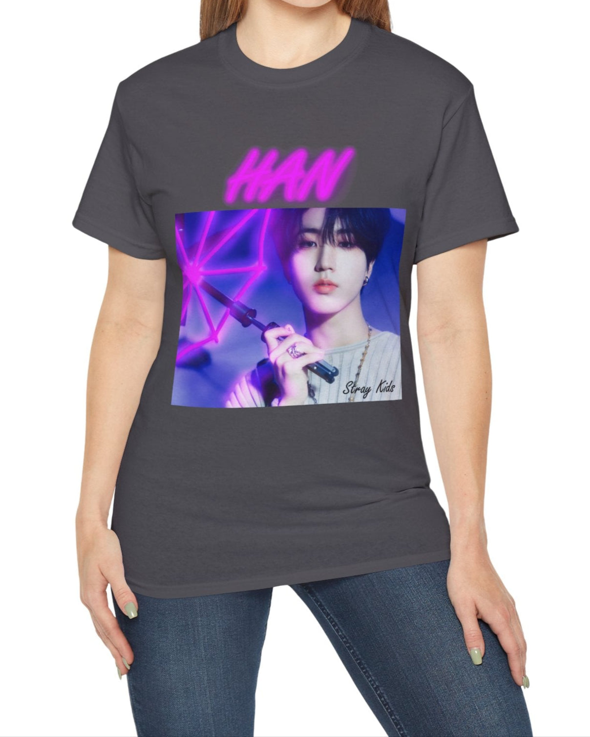 Han Stray Kids unisex T-shirt in charcoal, featuring a vivid pink neon umbrella design. Han poses in soft lighting, blending calm intensity with futuristic K-pop energy. ModeK Vetements.