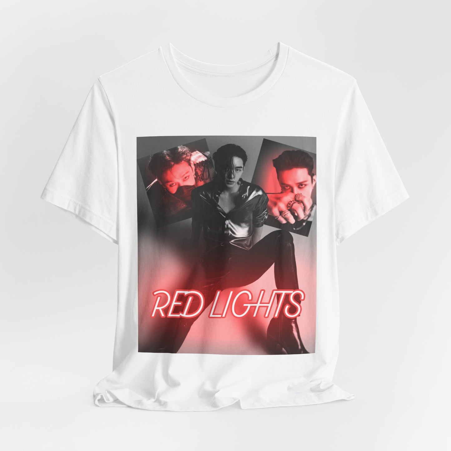 A draped presentation of the Hyunjin "Red Lights" Unisex T-Shirt, showcasing its black-and-white collage of Hyunjin against a dramatic red neon glow. The premium 100% Airlume combed cotton fabric hangs softly, highlighting its lightweight and breathable quality, while the design's moody lighting and bold composition remain striking. From ModeK Vetements.