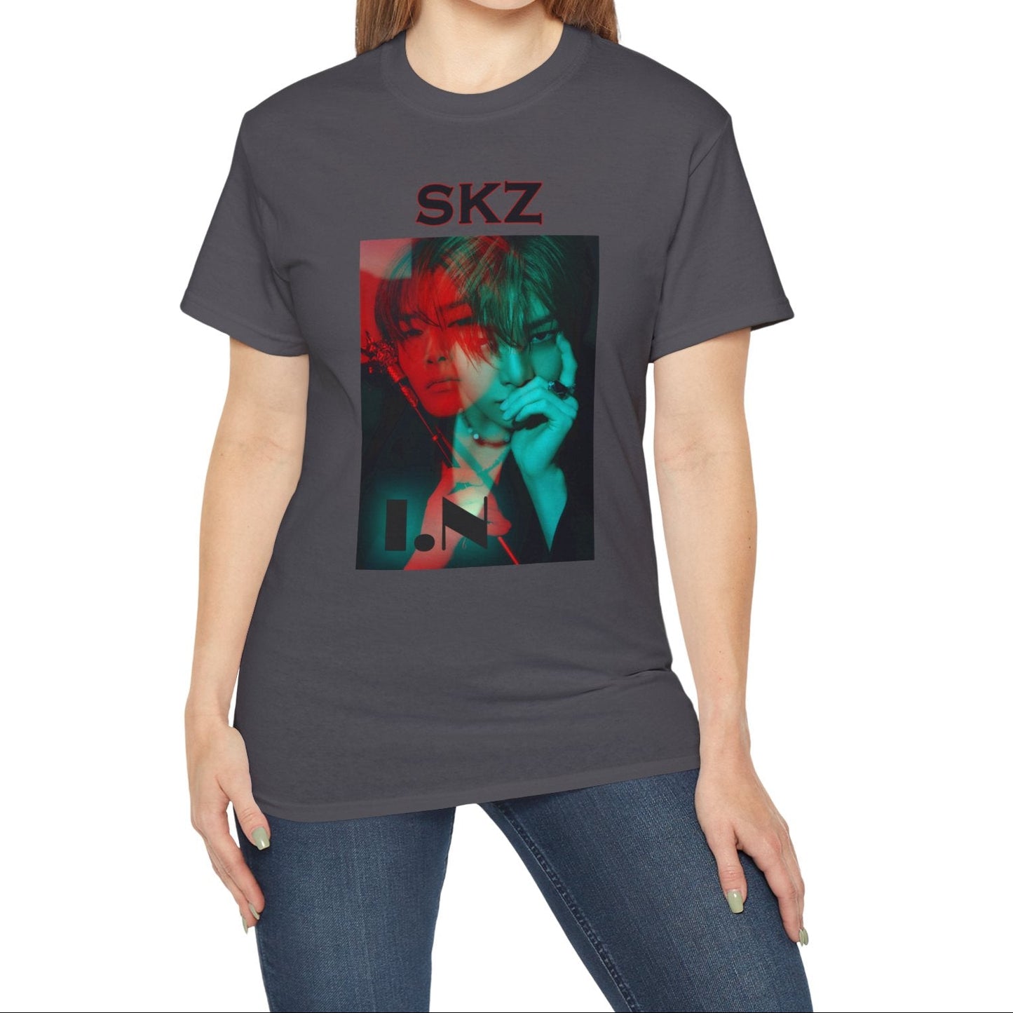 I.N Stray Kids unisex T-shirt in charcoal, featuring a bold black-and-white portrait with a dual-tone red and teal overlay. The striking 3D-like effect, combined with "SKZ" typography and I.N’s name, creates a modern, edgy aesthetic. Made from 100% cotton for lightweight comfort. From ModeKVetements.