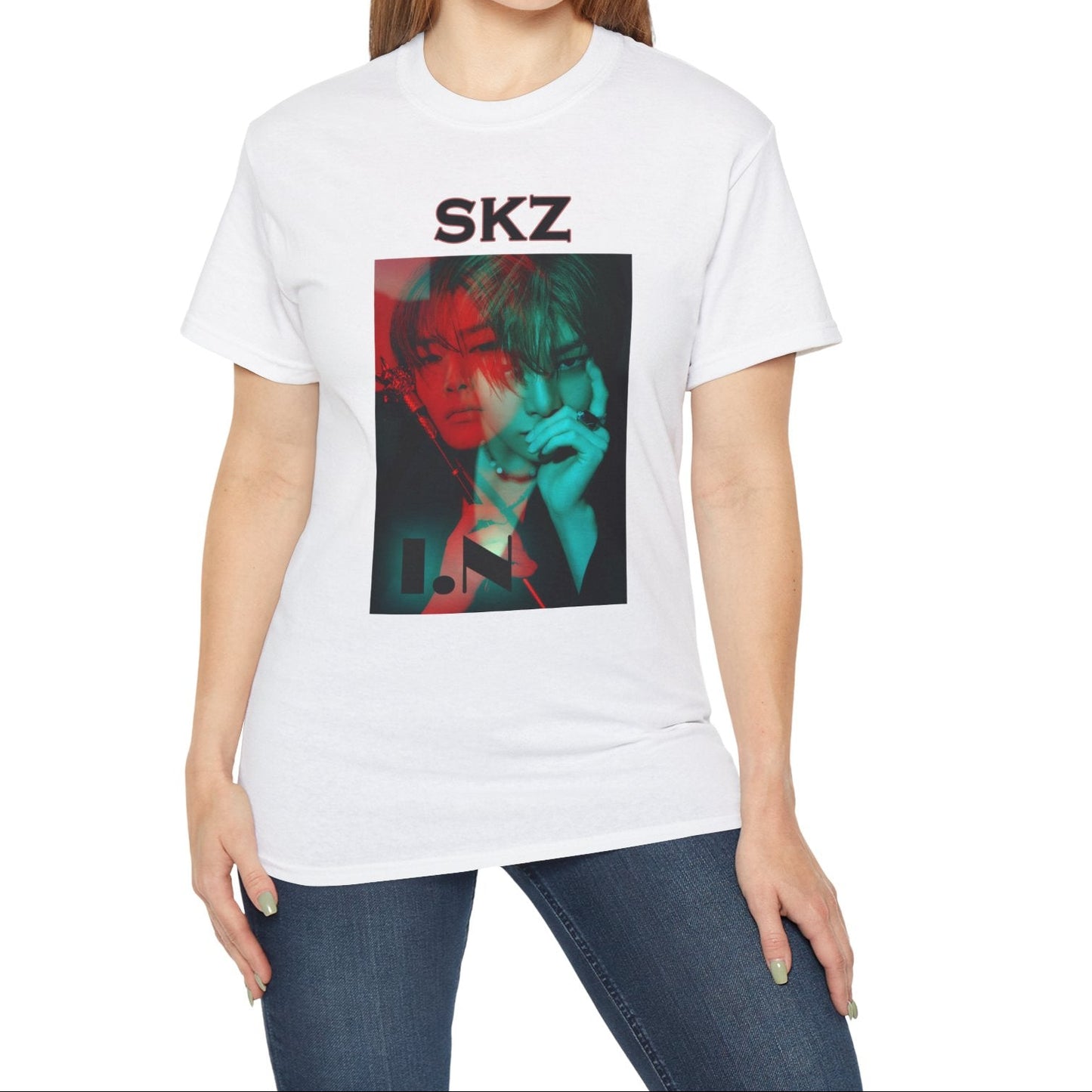 I.N Stray Kids unisex T-shirt in white, featuring a bold black-and-white portrait with a dual-tone red and teal overlay. The striking 3D-like effect, combined with "SKZ" typography and I.N’s name, creates a modern, edgy aesthetic. Made from 100% cotton for lightweight comfort. From ModeKVetements.