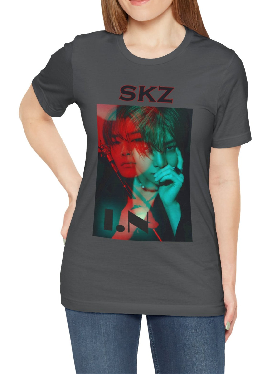 I.N Stray Kids unisex T-shirt in asphalt, featuring a bold black-and-white portrait with a dual-tone red and teal overlay. The striking 3D-like effect, combined with "SKZ" typography and I.N’s name, creates a modern, edgy aesthetic. Made from 100% Airlume cotton for lightweight comfort. From ModeKVetements.