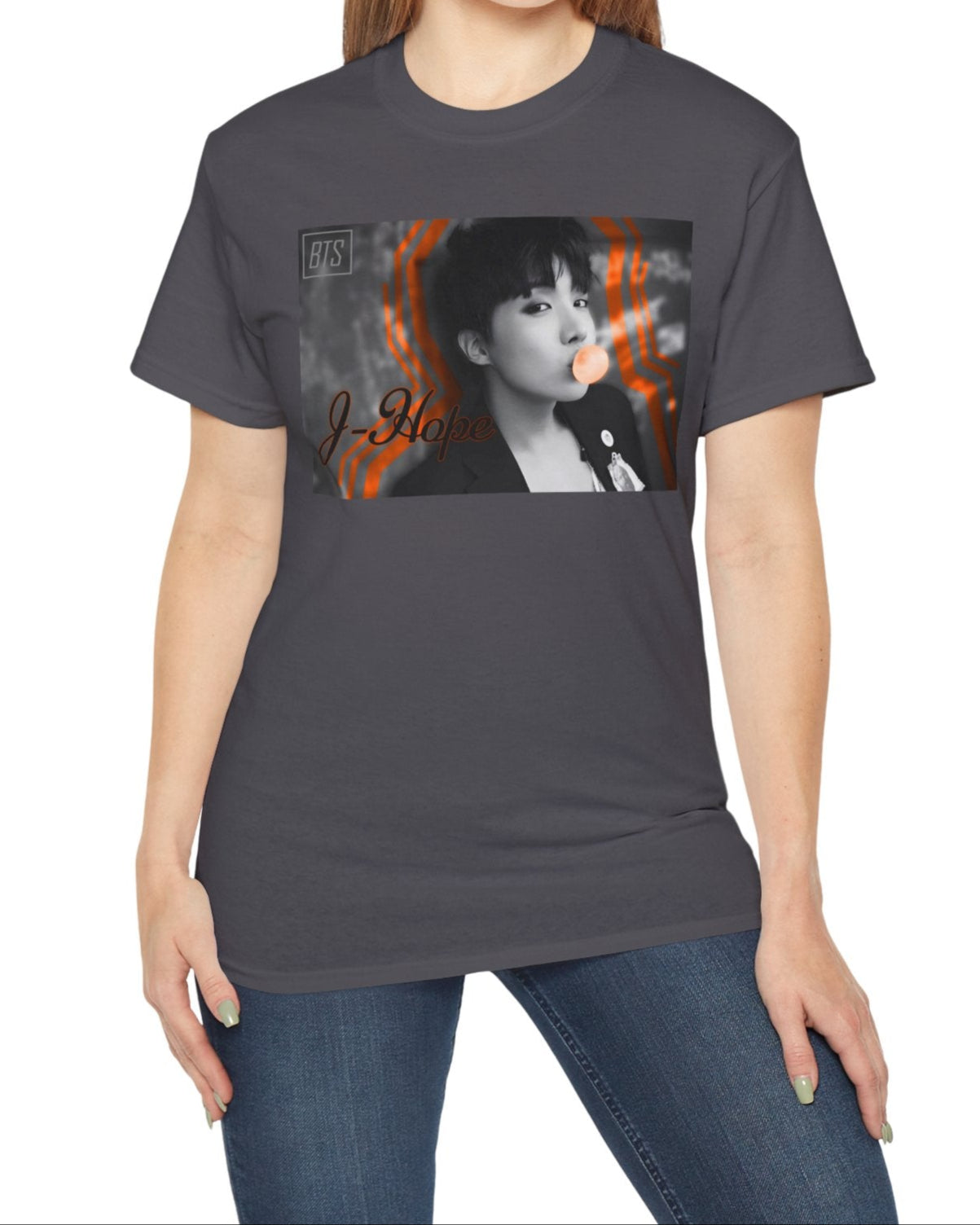 Black-and-white portrait of J-Hope of BTS blowing peach bubblegum, accented with bold deep orange contour lines — playful and bold design on a unisex cotton T-shirt in charcoal. ModeK Vetements.