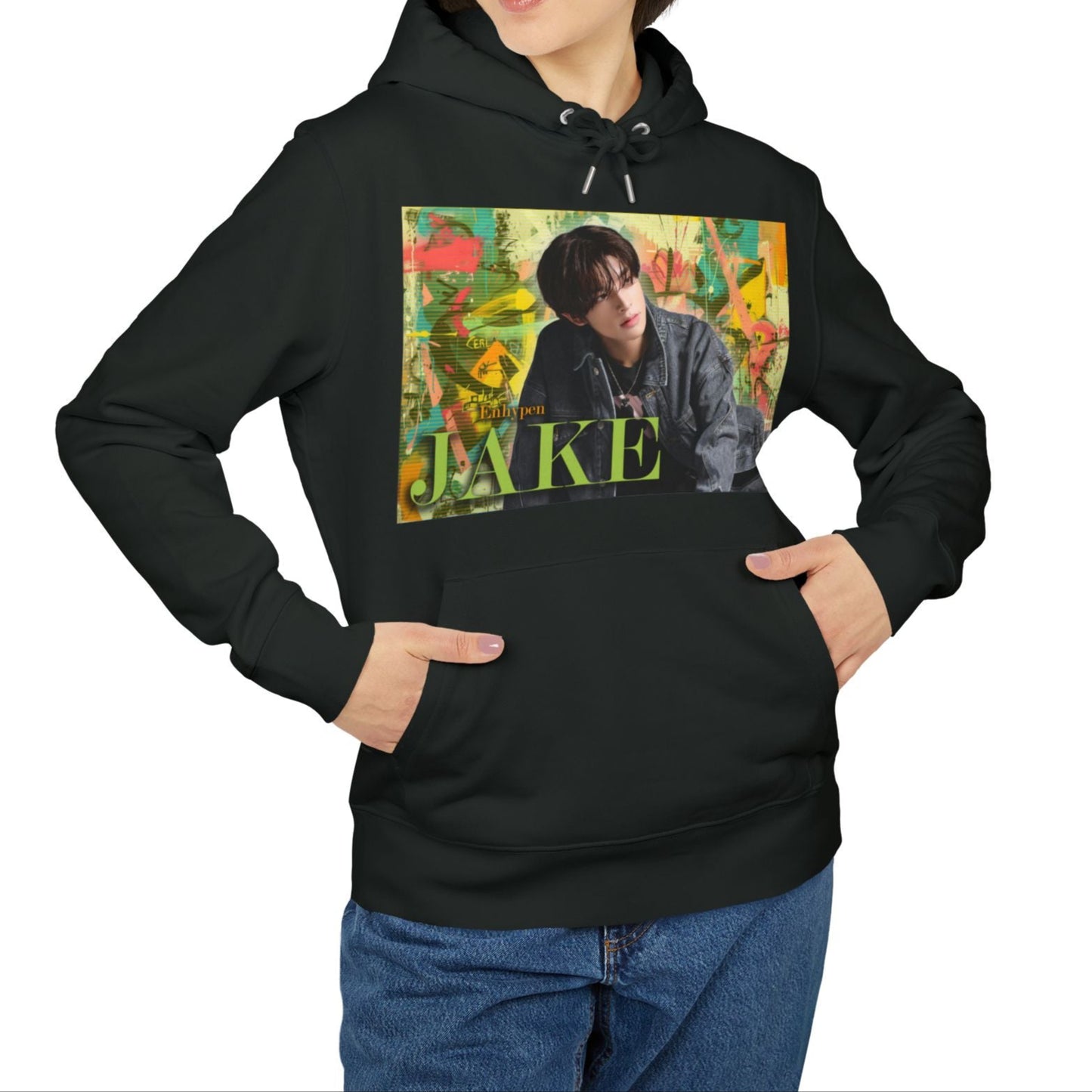 Unisex 100% Cotton Hoodie in black, featuring Jake of ENHYPEN framed in a layered pastel graffiti-style background, with calm expression and denim styling, surrounded by scanline textures. From ModeK Vetements.