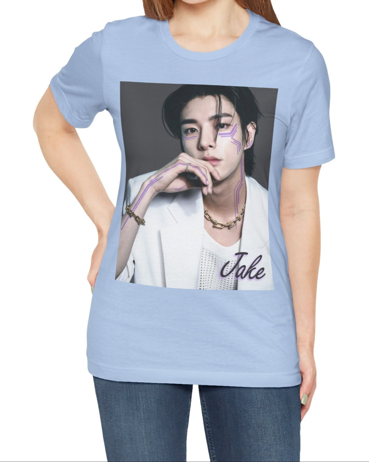 Unisex airlume cotton T-shirt in baby blue, featuring a print of Jake from ENHYPEN wearing a white jacket with notch lapels and a mesh knit shirt, adorned with bold gold chains and delicate light wisteria circuit-like tattoos emphasizing his cheekbones and jawline. ModeK Vetements.