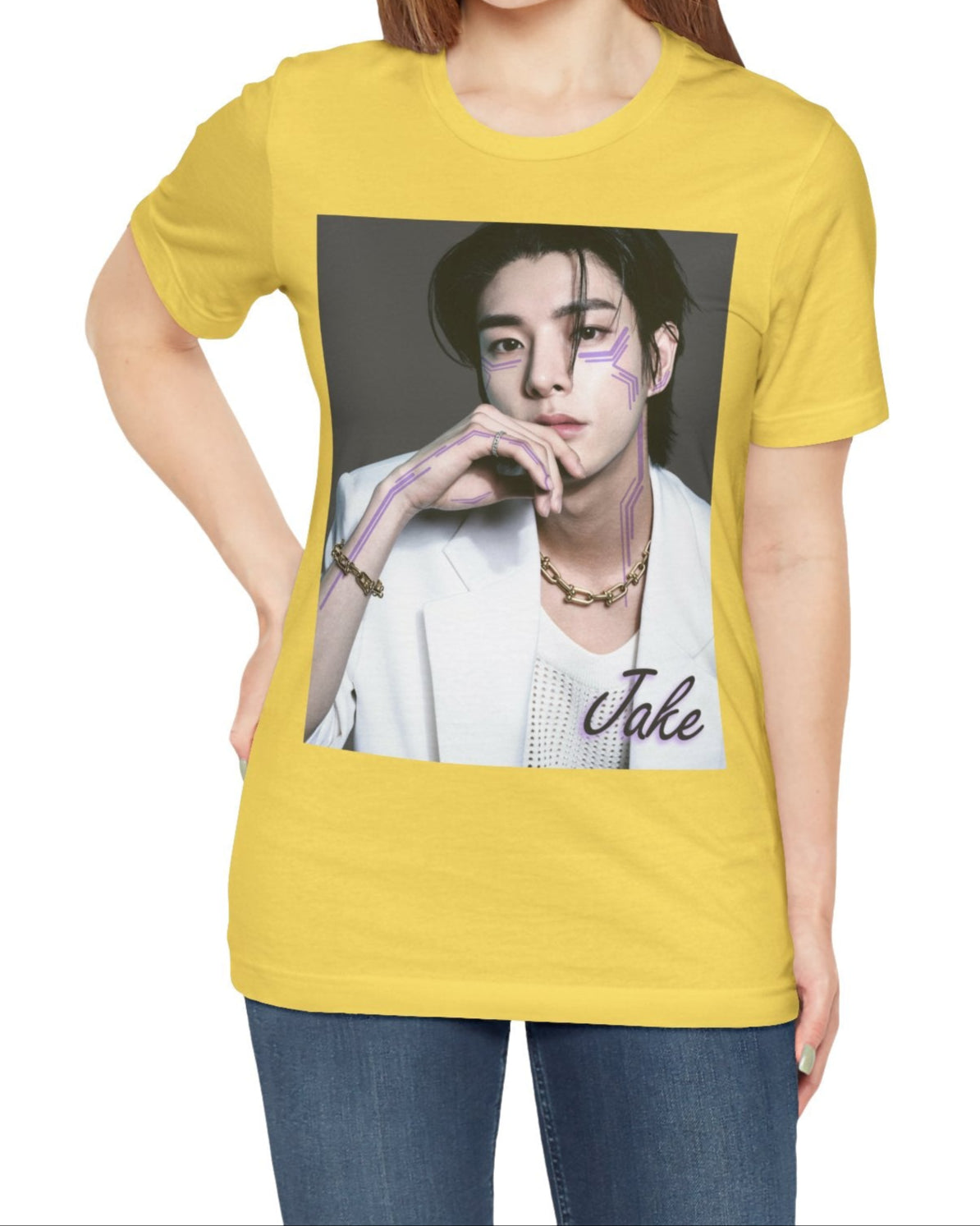 Unisex airlume cotton T-shirt in maize yellow, featuring a print of Jake from ENHYPEN wearing a white jacket with notch lapels and a mesh knit shirt, adorned with bold gold chains and delicate light wisteria circuit-like tattoos emphasizing his cheekbones and jawline. ModeK Vetements.