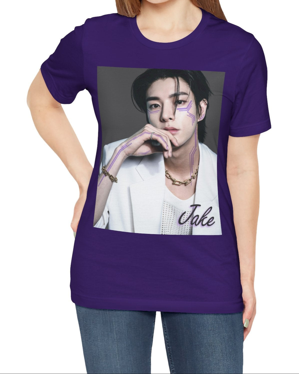 Unisex airlume cotton T-shirt in team purple, featuring a print of Jake from ENHYPEN wearing a white jacket with notch lapels and a mesh knit shirt, adorned with bold gold chains and delicate light wisteria circuit-like tattoos emphasizing his cheekbones and jawline. ModeK Vetements.