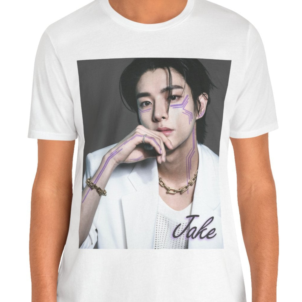 Unisex airlume cotton T-shirt in white, featuring a print of Jake from ENHYPEN wearing a white jacket with notch lapels and a mesh knit shirt, adorned with bold gold chains and delicate light wisteria circuit-like tattoos emphasizing his cheekbones and jawline. ModeK Vetements.