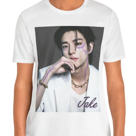 Unisex airlume cotton T-shirt in white, featuring a print of Jake from ENHYPEN wearing a white jacket with notch lapels and a mesh knit shirt, adorned with bold gold chains and delicate light wisteria circuit-like tattoos emphasizing his cheekbones and jawline. ModeK Vetements.