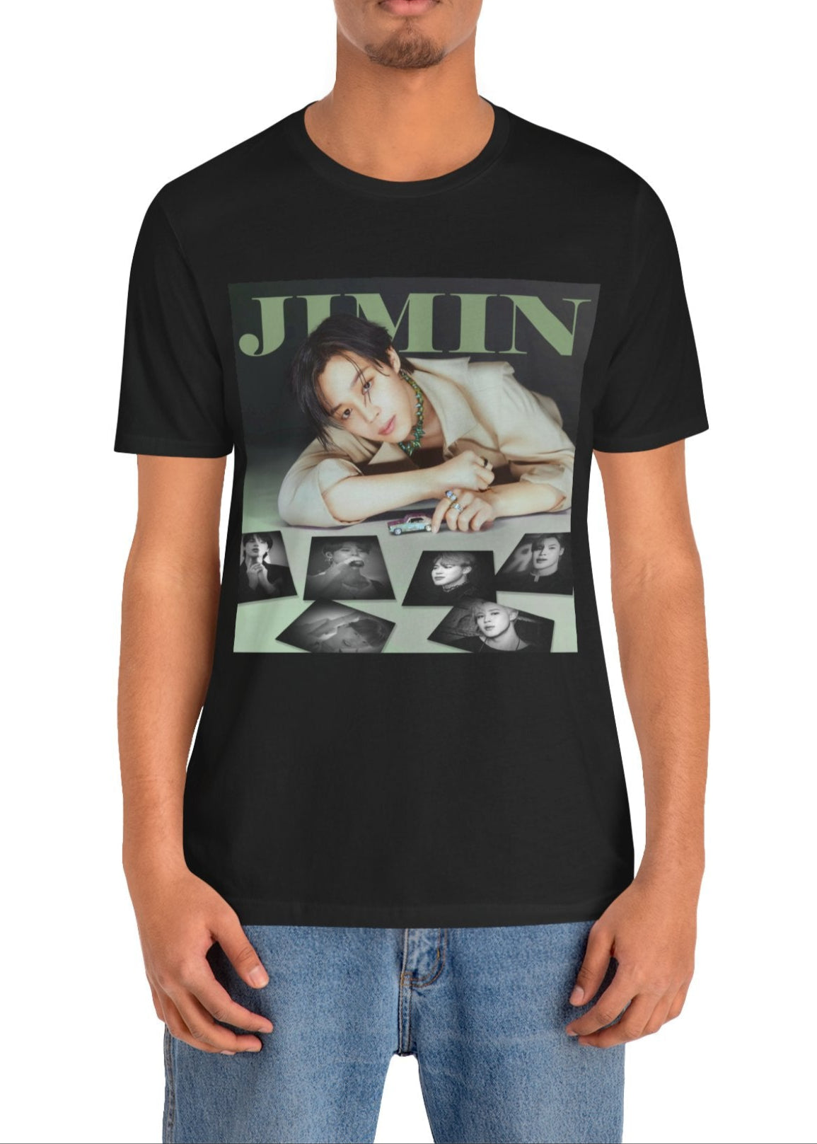 Jimin BTS Unisex T-Shirt in black – A Playful Charm. A stylish design featuring Jimin leaning forward while interacting with a miniature car. Soft, muted tones and balanced lighting highlight his delicate features, complemented by black-and-white portrait prints that add an editorial touch. ModeK Vetements.