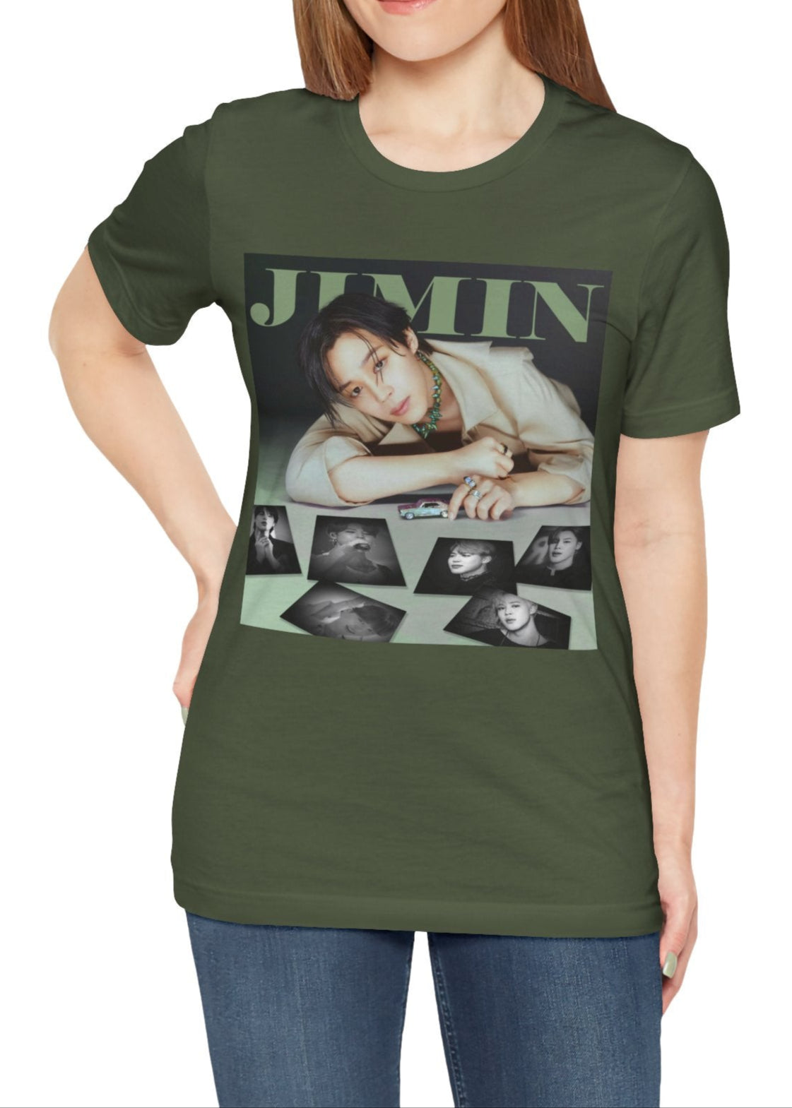 Jimin BTS Unisex T-Shirt in military green – A Playful Charm. A stylish design featuring Jimin leaning forward while interacting with a miniature car. Soft, muted tones and balanced lighting highlight his delicate features, complemented by black-and-white portrait prints that add an editorial touch. ModeK Vetements.