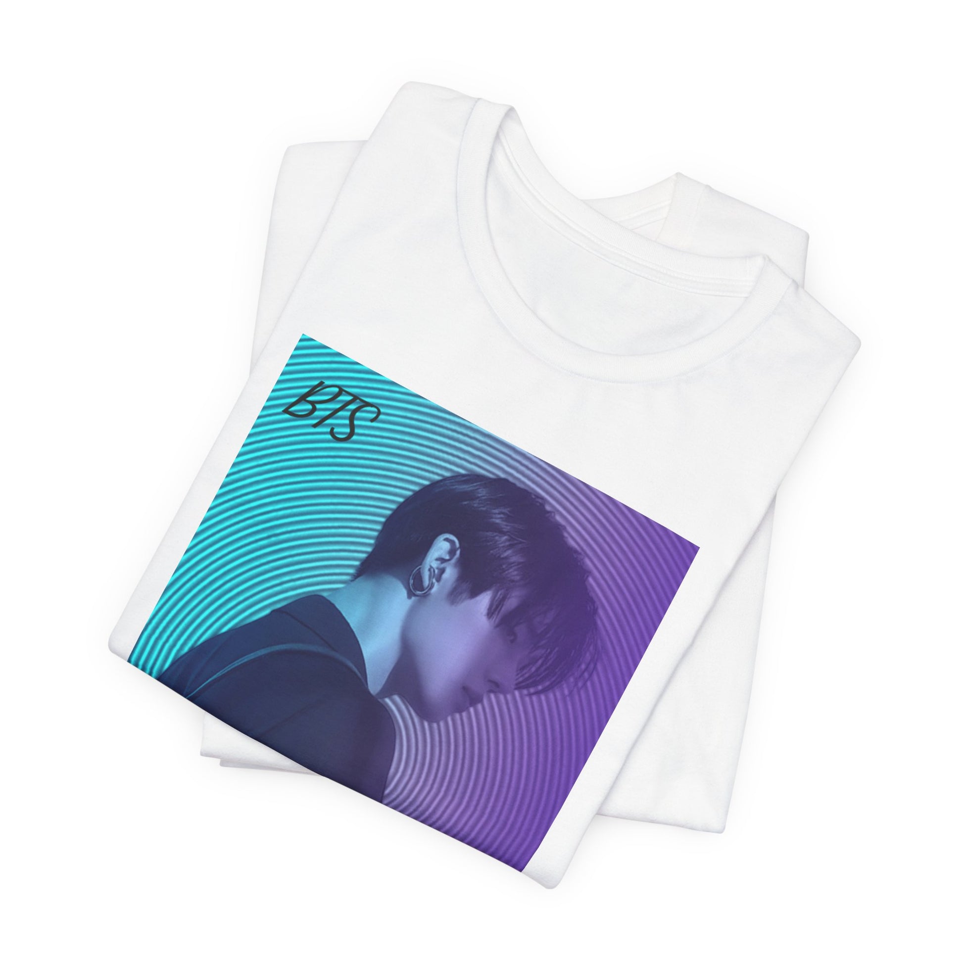 Folded Jung Kook BTS Unisex T-shirt in white, featuring a cyan-to-lavender gradient, vinyl-inspired circular background, retro lettering, and profile portrait with suit and leather bag – cinematic unisex style. 100% Airlume combed and ringspun cotton. ModeK Vetements.