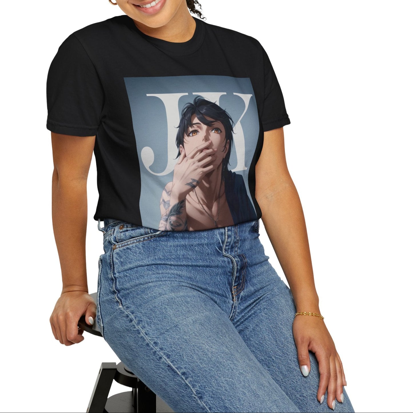 Model sitting on a stool and showcasing the Anime-style unisex T-shirt in black, featuring Jungkook, blending K-pop stage presence with anime aesthetics. The design captures his intense gaze, flowing hair, and striking composition, creating a fusion of two beloved art forms. Printed on soft, breathable ring-spun cotton for comfort and style. ModeK Vetements.