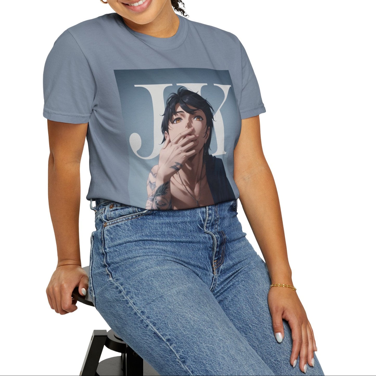 Model sitting on a stool and showcasing the Anime-style unisex T-shirt in blue jean, featuring Jungkook, blending K-pop stage presence with anime aesthetics. The design captures his intense gaze, flowing hair, and striking composition, creating a fusion of two beloved art forms. Printed on soft, breathable ring-spun cotton for comfort and style. ModeK Vetements.