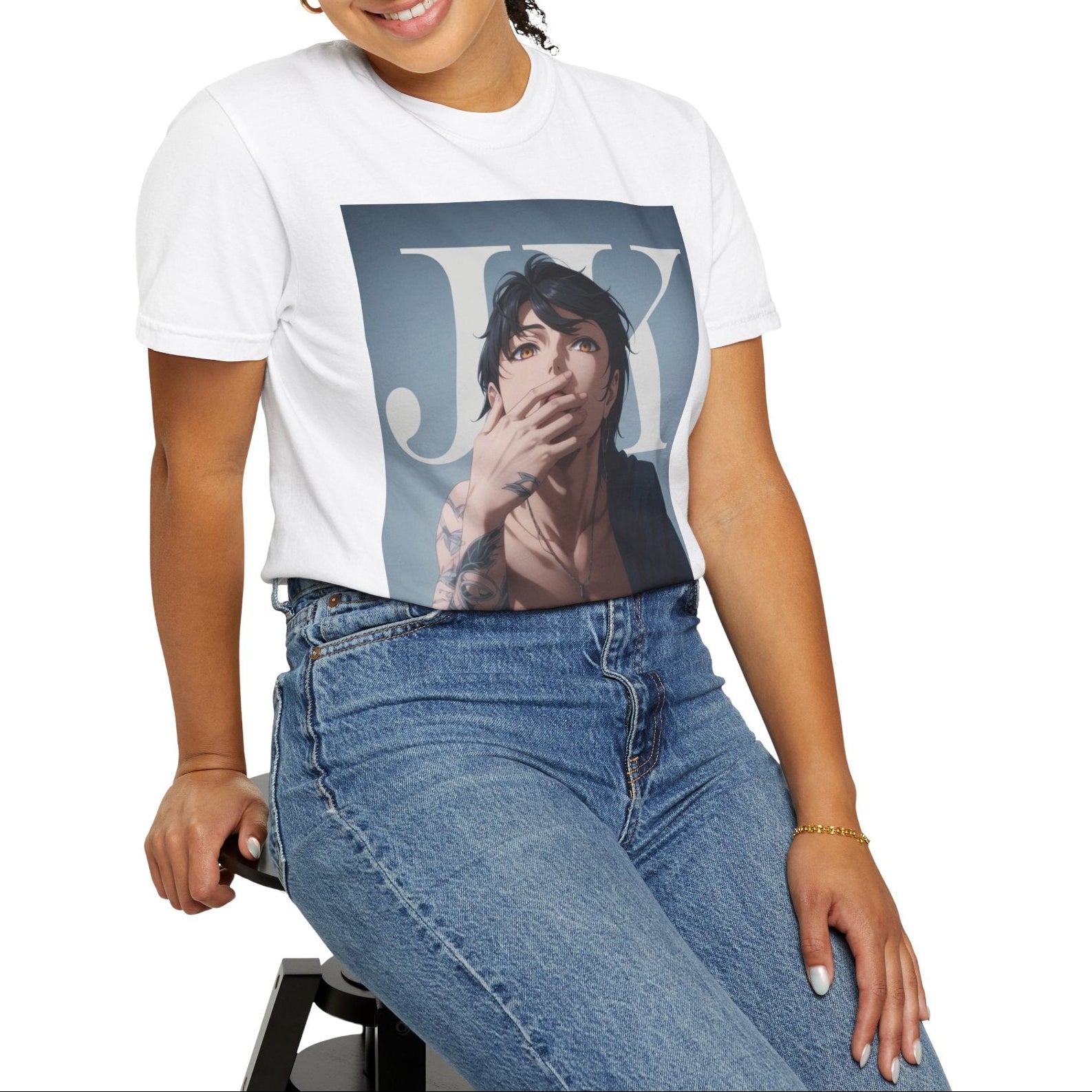 Model sitting on a stool and showcasing the Anime-style unisex T-shirt in white, featuring Jungkook, blending K-pop stage presence with anime aesthetics. The design captures his intense gaze, flowing hair, and striking composition, creating a fusion of two beloved art forms. Printed on soft, breathable ring-spun cotton for comfort and style. ModeK Vetements.