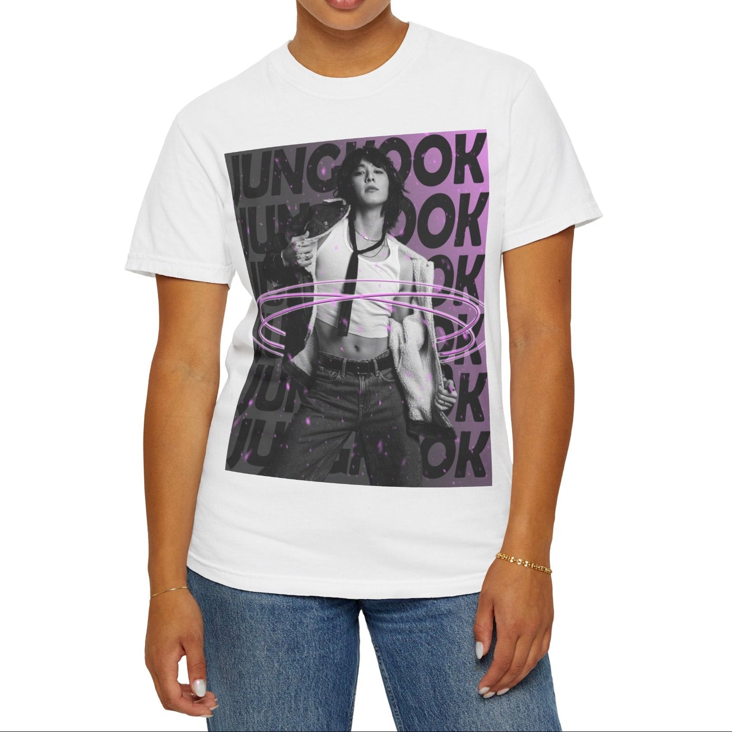 Unisex 100% ring-spun cotton T-Shirt in white, featuring BTS's Jungkook. He is posing against a dark background with "JUNGKOOK" repeated in large black typography and a charcoal-lavender gradient with pink paint splatters. Three glowing, thin magenta hoops encircle his waist, creating a sense of motion, making him even more provocative. From ModeK Vetements.
