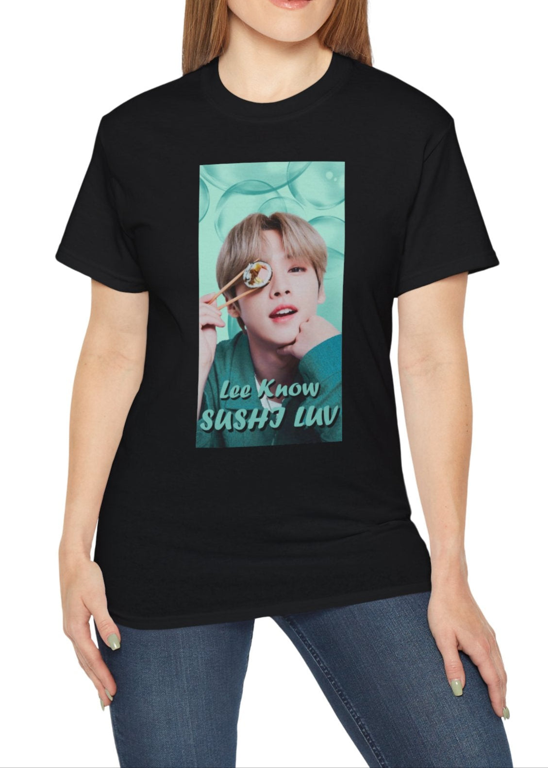 Lee Know Stray Kids Unisex T-Shirt in black, featuring a playful design with him holding sushi near his eye. The soft mint-green aesthetic enhances his charming and mischievous vibe. Printed on a high-quality cotton tee, available in XS-5XL. ModeK Vetements.