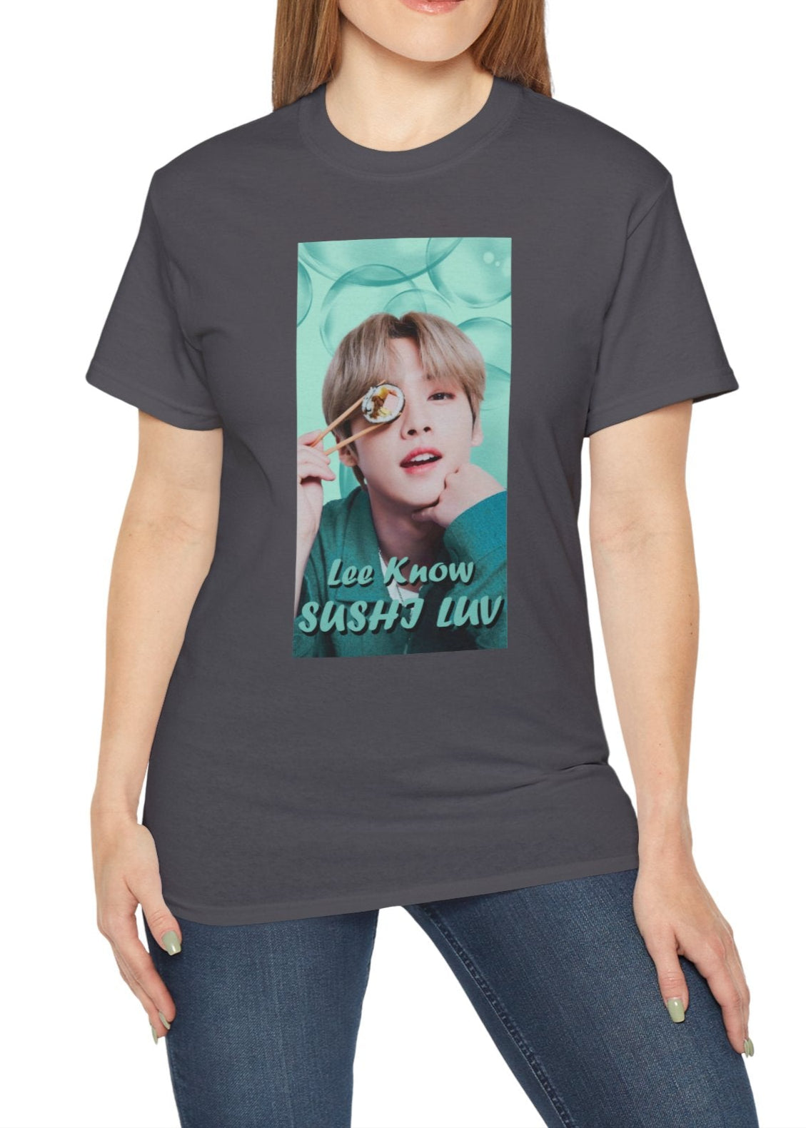 Lee Know Stray Kids Unisex T-Shirt in charcoal, featuring a playful design with him holding sushi near his eye. The soft mint-green aesthetic enhances his charming and mischievous vibe. Printed on a high-quality cotton tee, available in XS-5XL. ModeK Vetements.