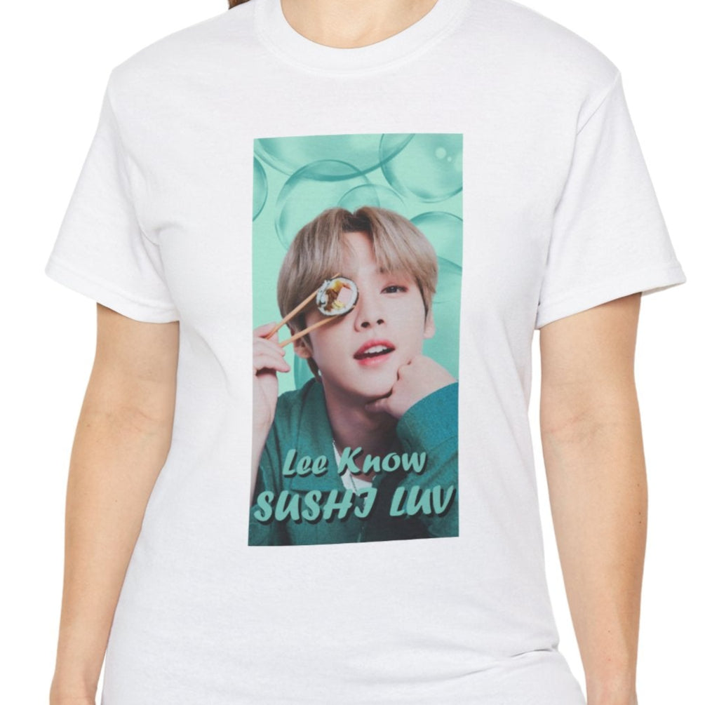 Lee Know Stray Kids Unisex T-Shirt in white, featuring a playful design with him holding sushi near his eye. The soft mint-green aesthetic enhances his charming and mischievous vibe. Printed on a high-quality cotton tee, available in XS-5XL. ModeK Vetements.