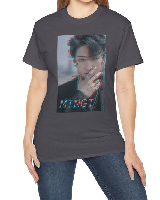 Mingi ATEEZ T-shirt in charcoal, featuring a glitch anaglyph design in turquoise and carmine red with scan lines, showing a bold portrait with a piercing gaze and rebellious rings. From ModeK Vetements.