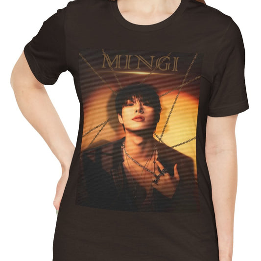 Mingi ATEEZ unisex T-shirt in brown, featuring a striking golden-hour portrait with a scan line effect. The warm sunset tones, layered chains, and bold typography enhance the dramatic, high-contrast aesthetic. Made from 100% Airlume cotton for a soft, breathable fit. From ModeKVetements.