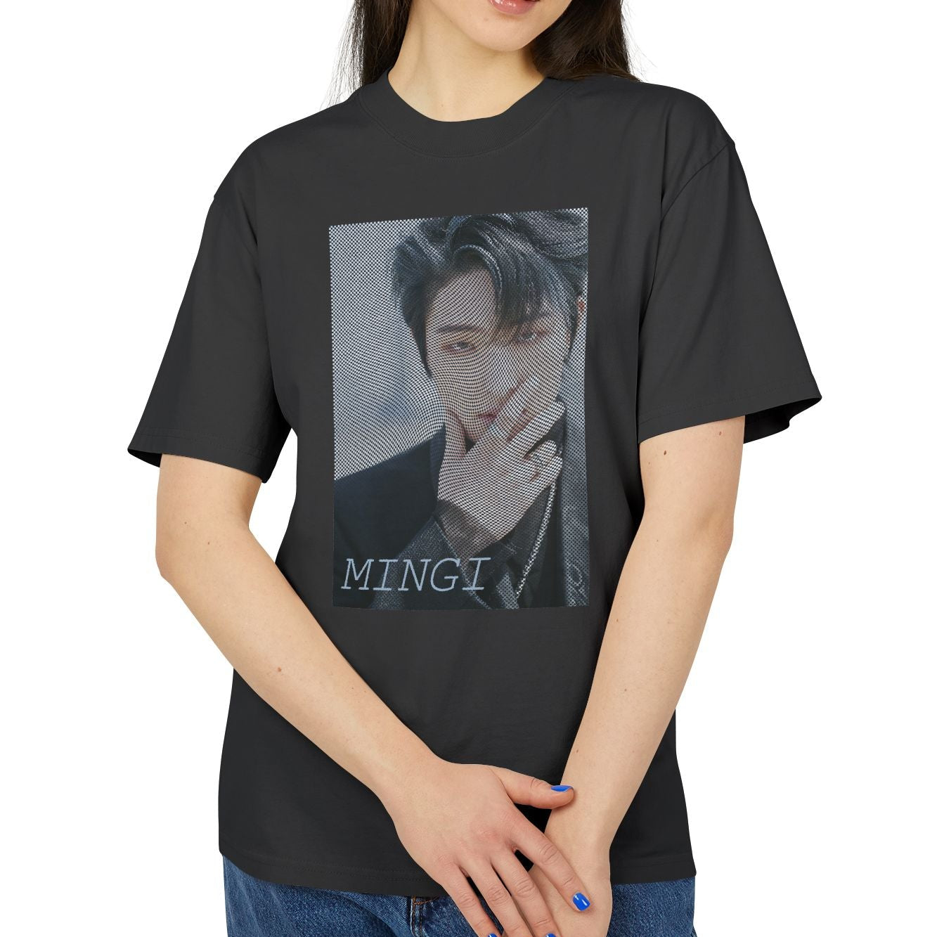 Unisex boxy T-Shirt in faded black, featuring a high-contrast graphic portrait of Mingi from the group ATEEZ, overlaid with a dense, wavy halftone moiré pattern. A fine black-and-white grid structure ripples across the image, distorting Mingi’s dark attire to create a powerful three-dimensional optical illusion of digital interference and textured depth. 100% carded cotton from ModeK Vetements.