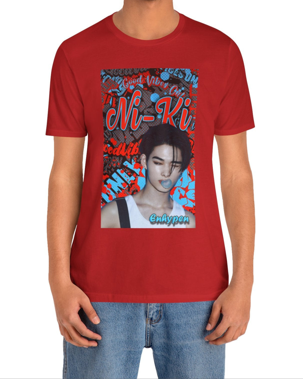 Unisex airlume cotton T-shirt in red, featuring Ni-Ki of ENHYPEN layered into a bold graffiti-style design with Rosso Corsa red and Malibu Blue. The layout includes digital splashes, checkerboard effects, and a bubble gum moment frozen mid-pop. From ModeK Vetements.