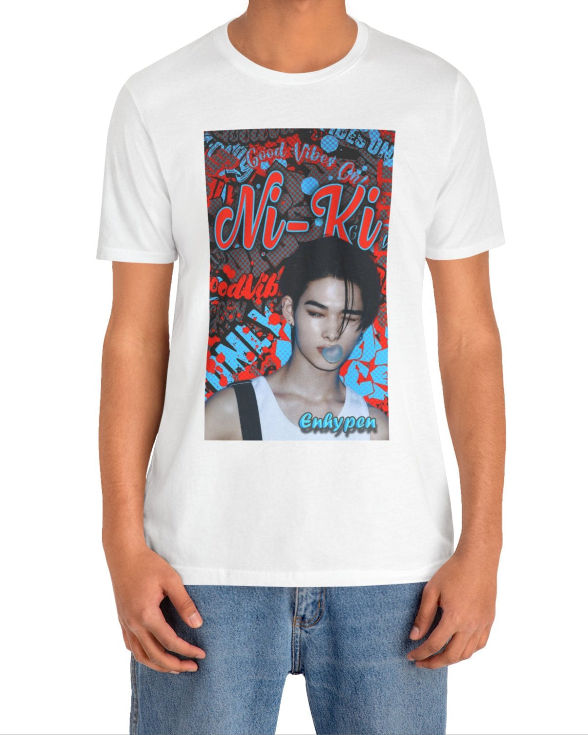 Unisex airlume cotton T-shirt in white, featuring Ni-Ki of ENHYPEN layered into a bold graffiti-style design with Rosso Corsa red and Malibu Blue. The layout includes digital splashes, checkerboard effects, and a bubble gum moment frozen mid-pop. From ModeK Vetements.