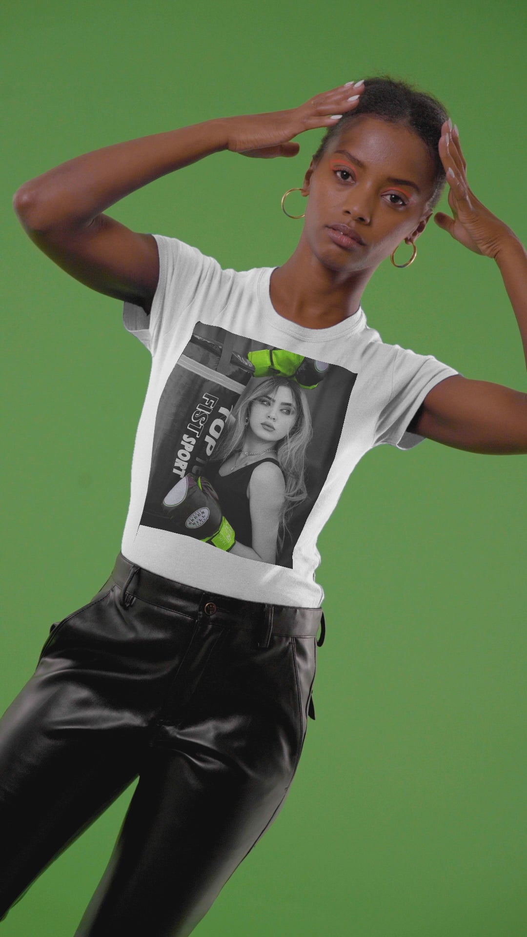 Video showcasing the Unisex t-shirt featuring a monochrome design of a woman with neon green boxing gloves. The bold contrast emphasizes her delicate features, blending strength and femininity. ModeK Vetements.
