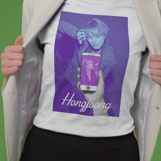 Video showcasing the Unisex t-shirt in white, from airlume combed and ringspun cotton, featuring a Printed design of Hongjoong from ATEEZ in a surreal phone screen composition. The background in blueberry contrasts with a purple-toned image on the phone, evoking alternate perspectives or layered realities. From ModeK Vetements.