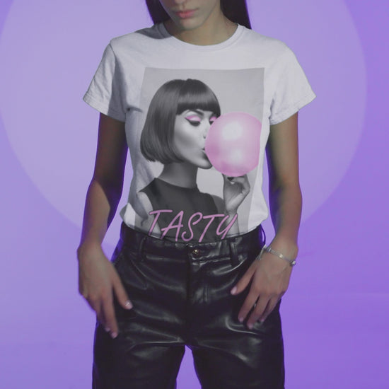 Video showcasing the stylized black-and-white portrait of a woman with a bob haircut blowing a bright pink bubblegum bubble, printed on a T-shirt in white, with the word “TASTY” in pink script. ModeK Vetements.