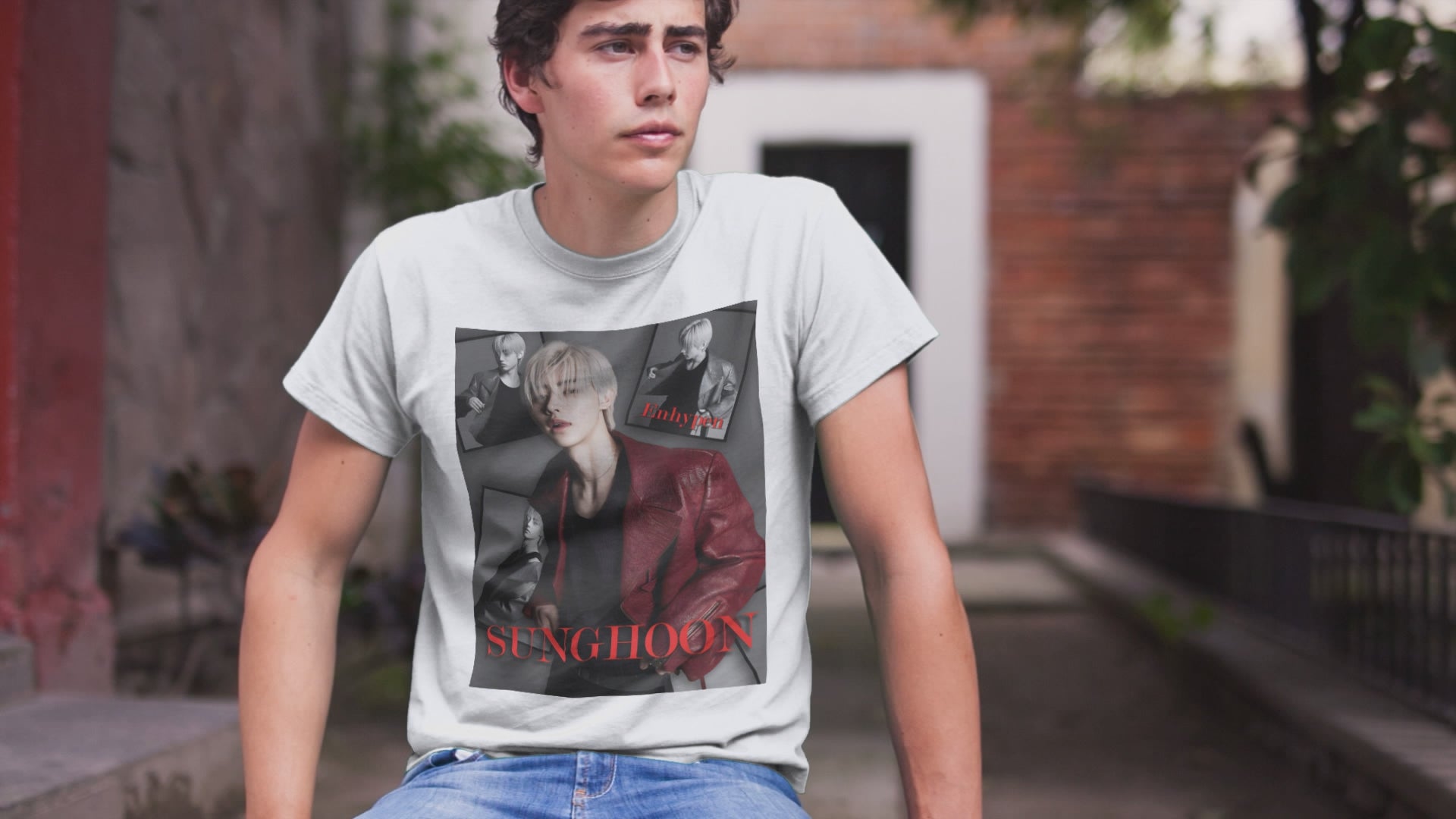 Video showcasing a Unisex airlume combed and ring-spun cotton T-shirt in white, featuring Sunghoon of ENHYPEN in a high-fashion monochrome collage. Styled in a red leather jacket, he appears paused mid-glance, framed by cinematic shadows in a Giallo Noir atmosphere. Editorial composition, smooth fabric, soft print finish. From ModeK Vetements.