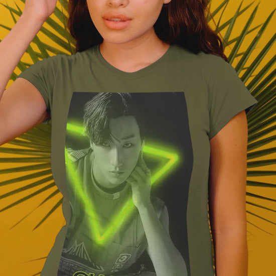Video showcasing the Choi San ATEEZ unisex cotton t-shirt in military green, featuring a black-and-white portrait with a neon-inspired green triangle behind him. His hand touches the glowing edge. Printed on 100% US cotton, ethically made and Oeko-Tex certified. ModeK Vetements.