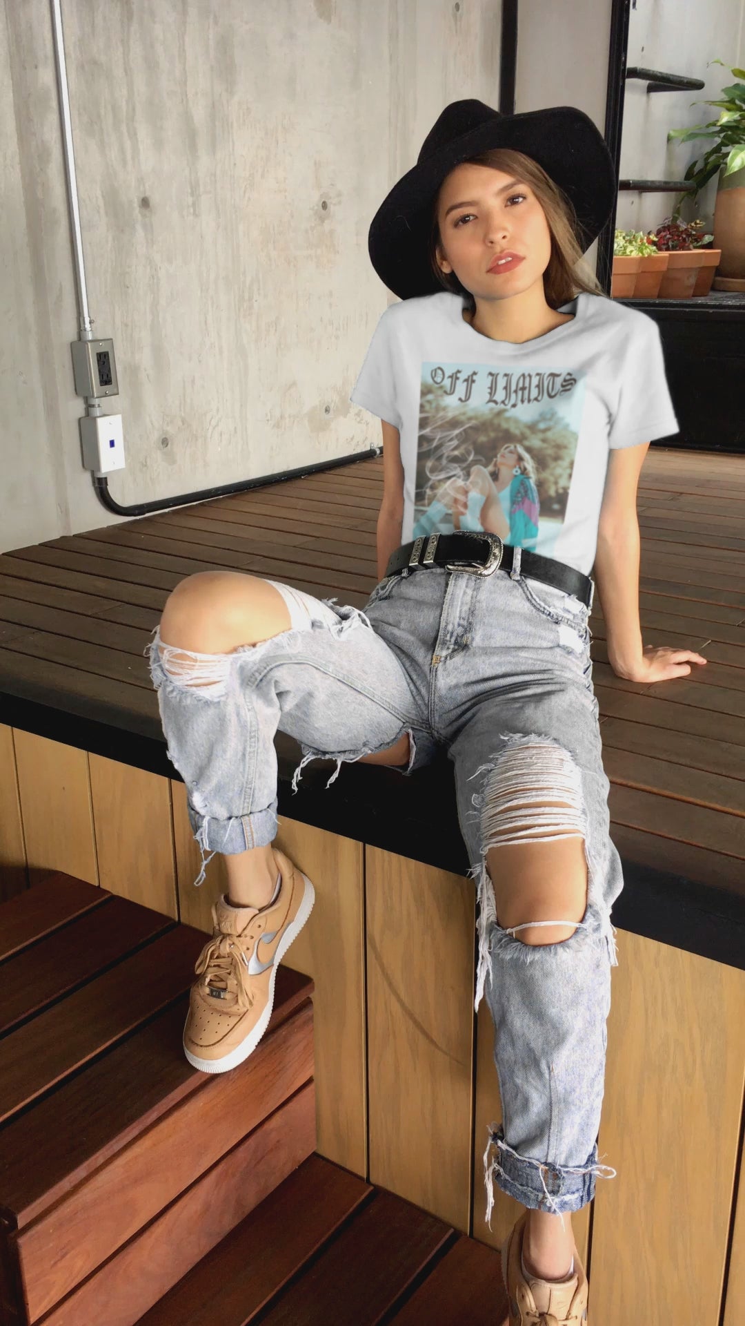 Video showcasing the Unisex airlume cotton t-shirt in white, featuring a woman in retro rollerblades with smoke rising from the wheels, resting confidently beneath "Off Limits" in bold gothic font - a statement of freedom and attitude. From ModeK Vetements.