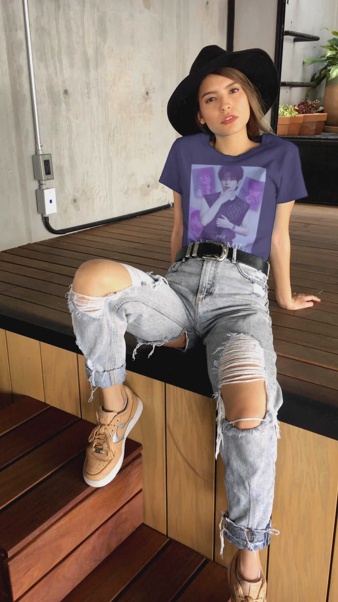 Video showcasing the unisex, jersey, airlume combed and ringspun cotton T-Shirt in team navy, with a graphic design. It features Stray Kids' Seungmin in a sleeveless crochet top and blueberry tie. He poses thoughtfully against a periwinkle backdrop with a mist-covered collage of lavender, magazine-style photos. At the bottom, "SKZ SEUNGMIN" is written in pale lily-blue with a soft drop shadow. From ModeK Vetments.