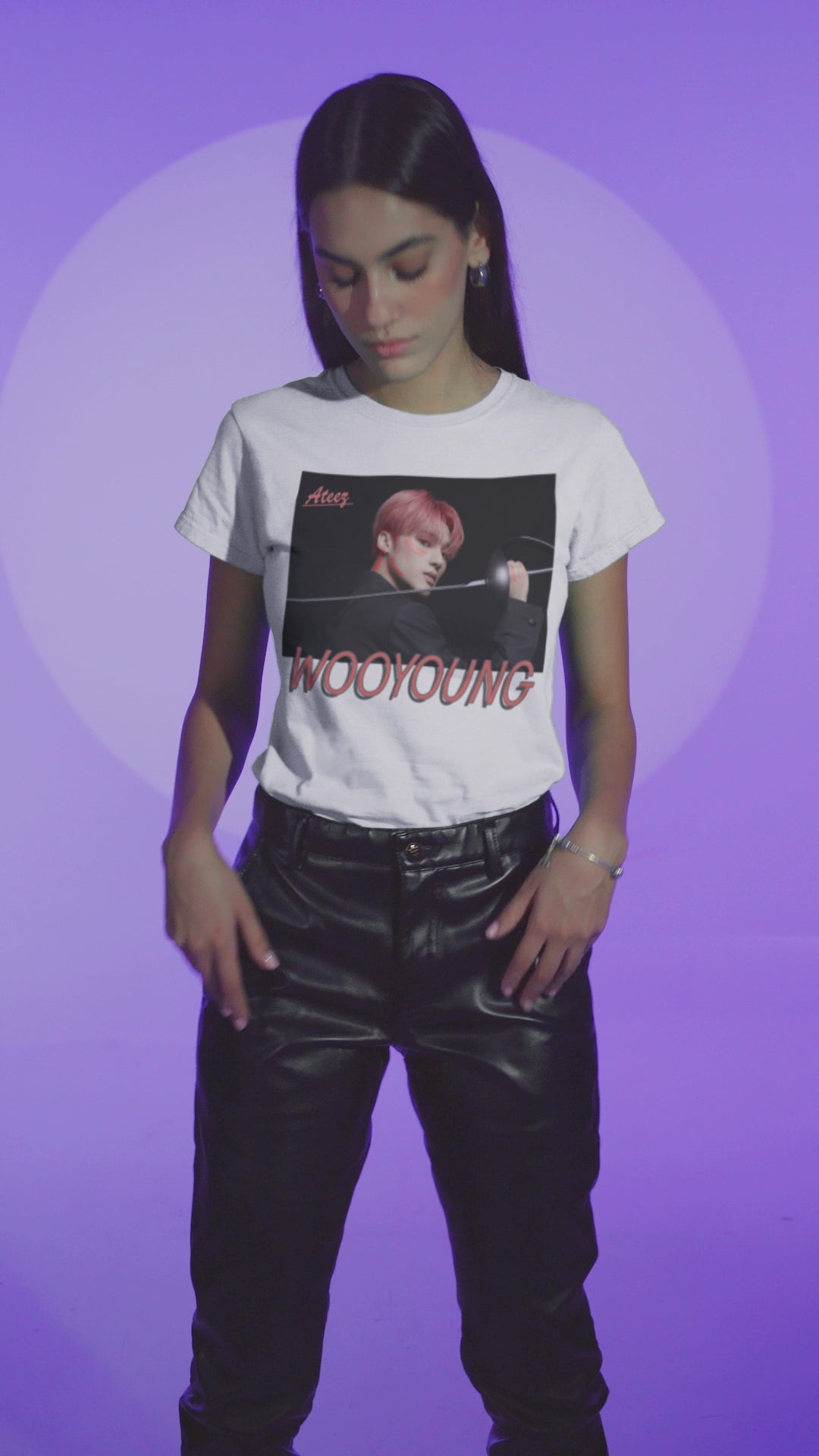 Video showcasing the Wooyoung ATEEZ Unisex T-Shirt featuring a striking design of Wooyoung wielding a sword, his pink-red hair and sharp cheekbones illuminated by dynamic lighting. A must-have for ATINY.