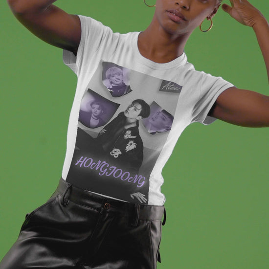 Video showcasing the Unisex cotton t-shirt in white, featuring a photo collage of Hongjoong from ATEEZ. The central image shows him seated in a black jacket with raised beaded embellishments—a snake and flowers—surrounded by soft violet portraits. The name "HONGJOONG" appears in purple script below the collage. ModeK Vetements.