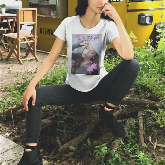 Unisex T-shirt featuring a dreamy photo of a woman with closed eyes, a soft expression, and a pink paint splash over her chest. The words “FALLEN FOR YOU” appear in bold pink lettering at the top. ModeK Vetements.