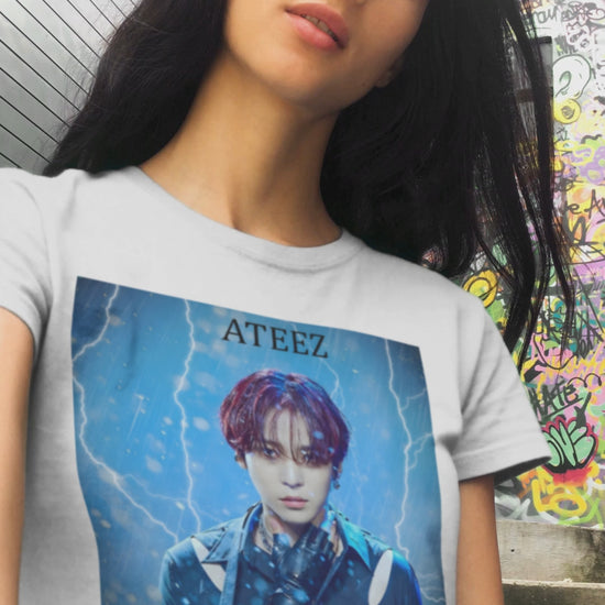 Video showcasing the Yunho ATEEZ unisex cotton t-shirt in white, featuring a stormy design with rain, lightning, red hair, leather glove, cut-out shoulder slits, and metal accessories. Printed on 100% US cotton, ethically made and Oeko-Tex certified. ModeK Vetements.