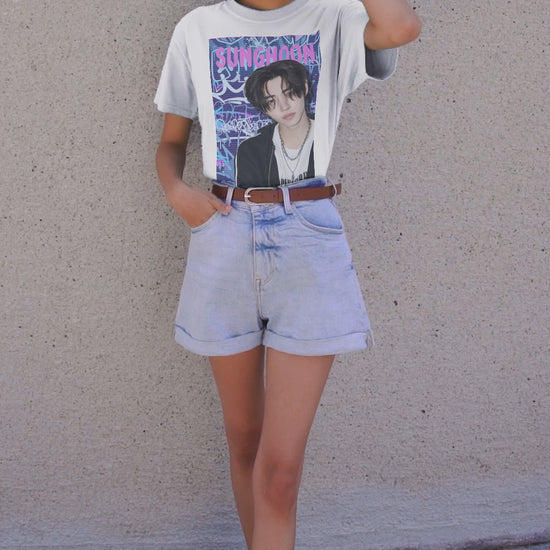 Video showcasing the Unisex oversized heavy cotton T-shirt in white, featuring Sunghoon of ENHYPEN against a violet-blue graffiti backdrop with scan line overlay. From ModeK Vetements.