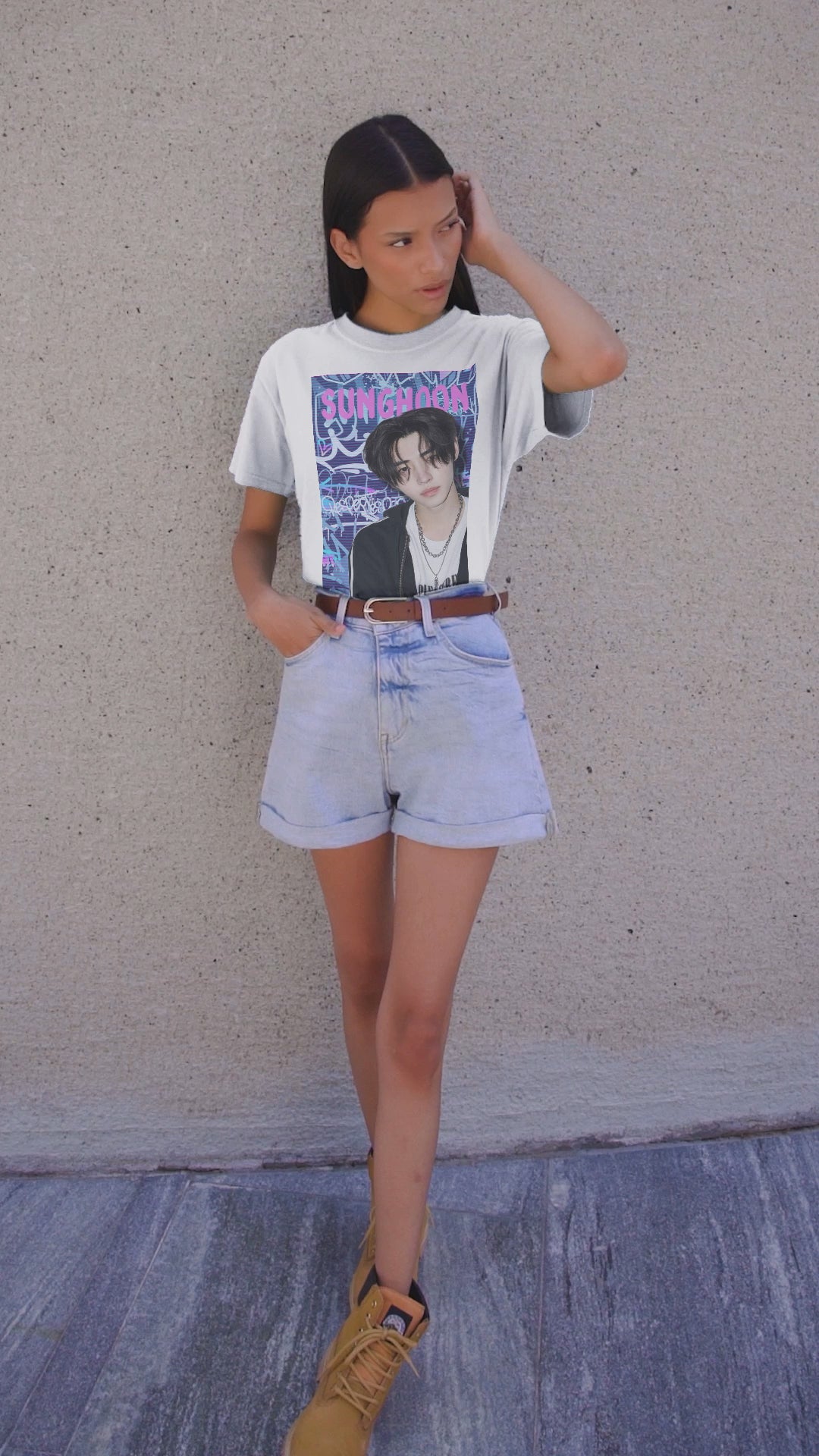 Video showcasing the Unisex oversized heavy cotton T-shirt in white, featuring Sunghoon of ENHYPEN against a violet-blue graffiti backdrop with scan line overlay. From ModeK Vetements.