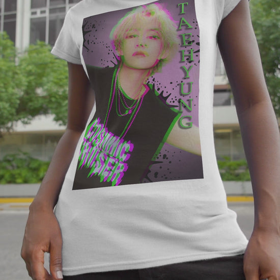 Video showcasing the V Taehyung BTS unisex t-shirt in white, featuring a glitch-effect design in green and magenta with paint splatters, purple gradient background, and Cosmic Cruiser text. Printed on 100% US cotton, ethically made and Oeko-Tex certified. ModeK Vetements.