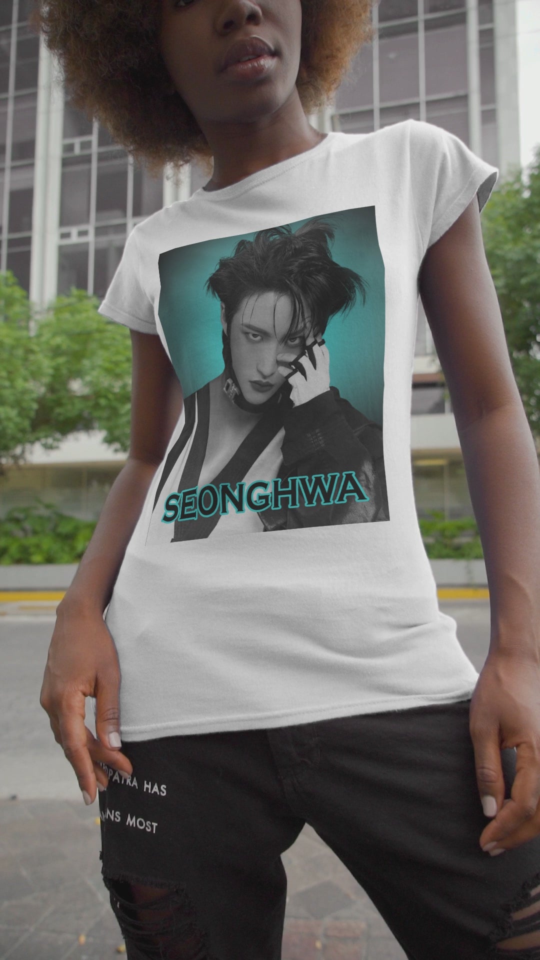 Video showcasing the Seonghwa ATEEZ Unisex T-Shirt in white – Experiment in Contrasts. A striking black-and-white portrait of Seonghwa with dramatic lighting, deep shadows, and a piercing gaze. His darkened lips add an intense edge, while a bold teal glow surrounds him, creating a contrast between elegance and raw energy. ModeK Vetements.