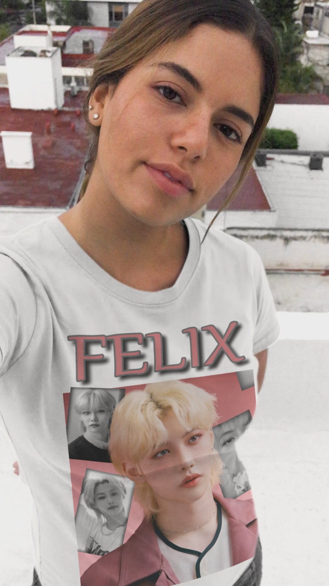 Video showcasing the Felix Stray Kids unisex T-shirt in white, with a blush pink and black-and-white collage design. Made from ethically sourced US cotton with a classic tubular knit construction. ModeK Vetements.