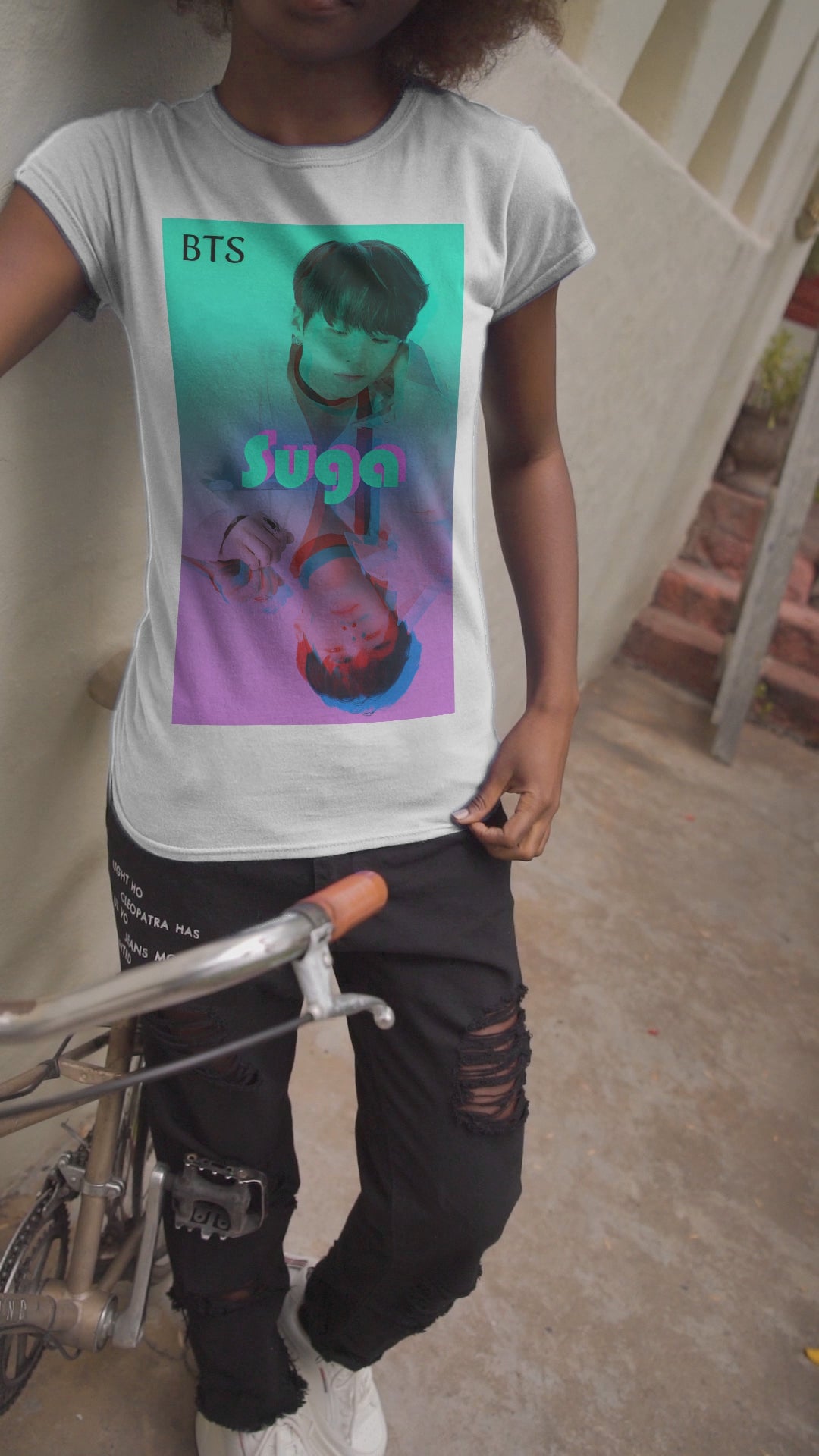 Video showcasing a Unisex cotton T-shirt in white, featuring Suga of BTS (Agust D) in cyan, looking into a mirror. His lavender reflection appears glitched, starting at his right hand. The surreal gradient and distortion suggest a drifting, dreamlike moment out of sync with reality. From ModeK Vetements.